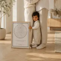 A toddler standing beside a light wood framed white star map print in a bright modern living room
